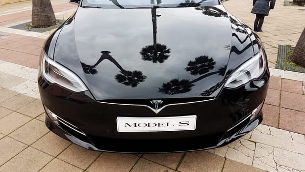 Menton, France - March 3, 2018: Black Tesla Model S (Front View) Electric Car Parked on a Square in Menton on The French Riviera. The Tesla Model S is a Luxury Full-Sized Electric Five Door .
