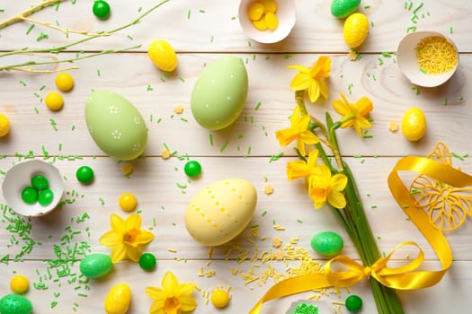 easter background with easter eggs and spring flowers. top view
