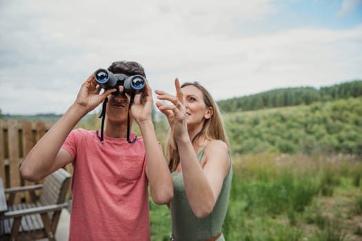 Mother and son using some binoculars while on holiday.