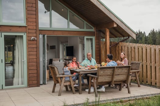 Family having their breakfast outside the holiday cottage.