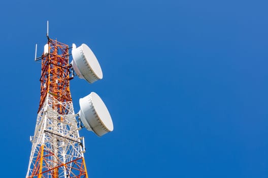 Telecommunication tower on blue sky blank background. Used to transmit television and telephony signal