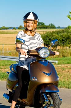 Young woman on the scooter