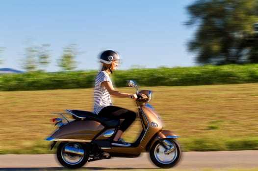 Young woman on the scooter