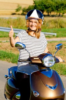 Young woman with thumbs on top of the motorroler