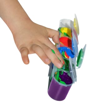 kid paints with her fingers with different color paint