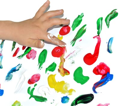 Kid paints with her fingers with different color paint