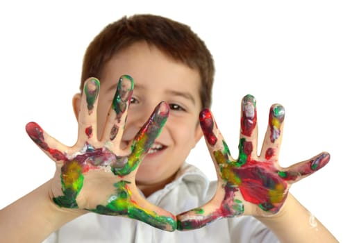 Little boy painting with hands with different color paint on his palms