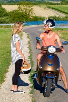 Young couple with scooter