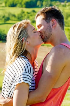 Young,happy couple kisses