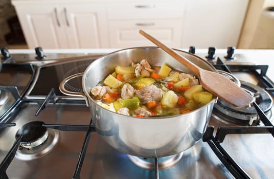 Cooking stew with vegetables and meat on the stove