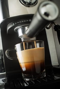 Espresso pouring from coffee machine. Professional coffee brewing