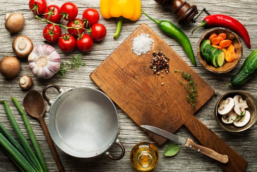 Fresh ingredients for cooking meal on wooden background place for text. Vegan food vegetarian and healthy cooking concept.