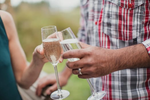 Couple making a celebratory toast with champagne.