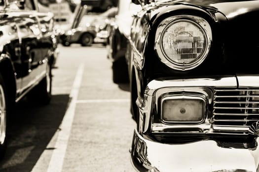 Photograph of a classic vehicle with close-up on headlights.