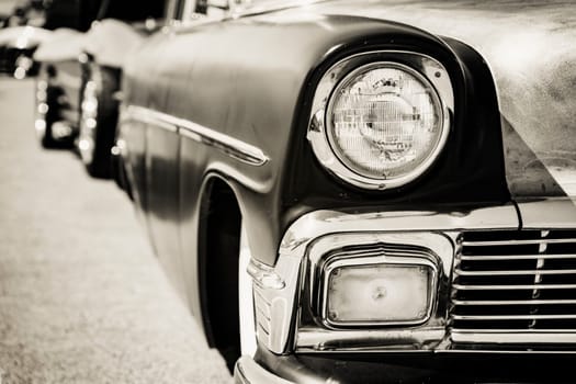 Photograph of a classic vehicle with close-up on headlights.
