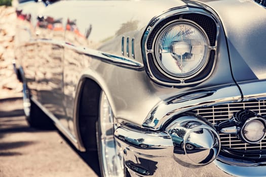 Photograph of a classic vehicle with close-up on headlights.
