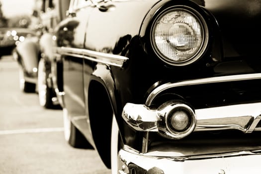 Photograph of a classic vehicle with close-up on headlights.