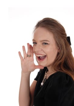 A beautiful young woman holding her hands on her mouth and .screaming with her mouth open, isolated for white background.