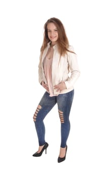 A portrait image of a beautiful young woman in jeans and a white .leather jacket standing isolated for white background.