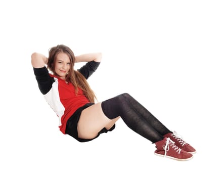 A young slim woman sitting on the floor in the studio doing sit-ups.in sportswear outfits, isolated for white background.
