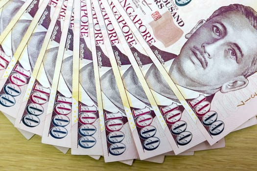 Singapore currency one thousand dollars bill notes fanned out closeup macro