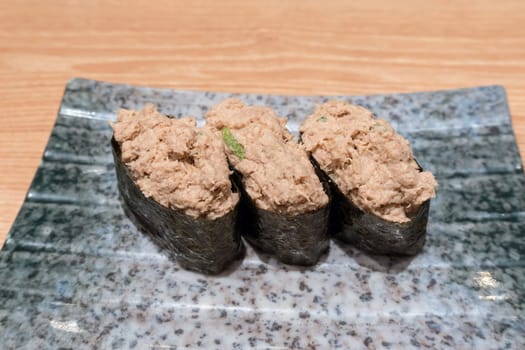Tuna Salad Japanese Sushi trio on ceramic plate closeup macro