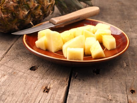 Sweet organic pineapple on a rustic wooden table