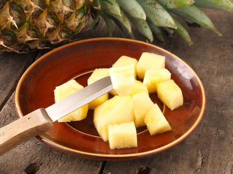 Sweet organic pineapple on a rustic wooden table
