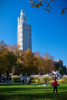 People in the city park of Magdeburg. In the background the observation tower. It is one of the city's landmarks