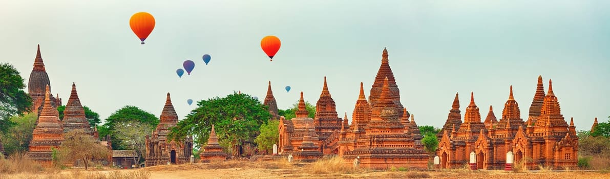 Balloons over Temples at sunrise in Bagan. Myanmar. Panorama