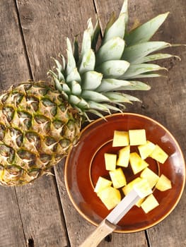 Sweet organic pineapple on a rustic wooden table