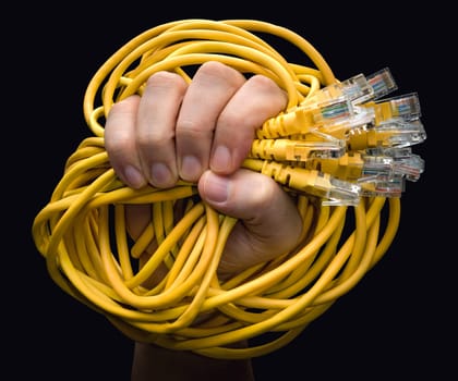 A hand holding several yellow RJ45 cables rolled up.