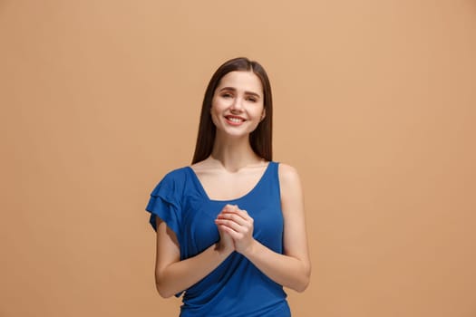 Beautiful female half-length portrait isolated on pastel studio backgroud. The young emotional happy woman standing and looking at camera.The human emotions, facial expression concept. Front view. Trendy colors