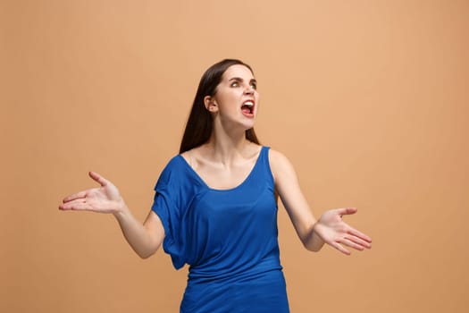 Screaming, hate, rage. Crying emotional angry woman screaming on pastel studio background. Emotional, young face. Female half-length portrait. Human emotions, facial expression concept. Trendy colors