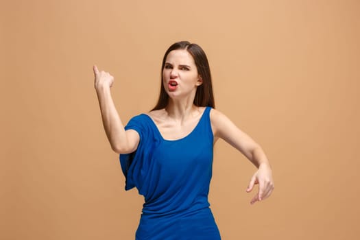 Screaming, hate, rage. Crying emotional angry woman screaming on pastel studio background. Emotional, young face. Female half-length portrait. Human emotions, facial expression concept. Trendy colors