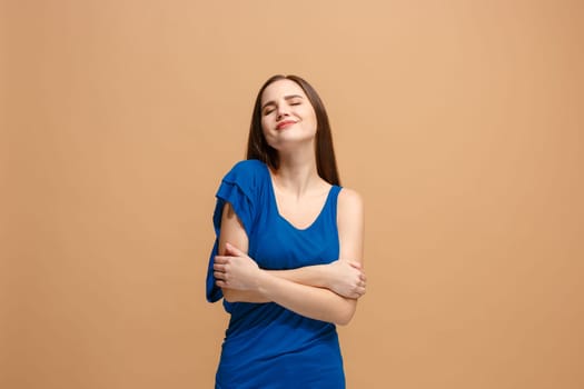 Happy business woman standing, smiling isolated on trendy pastel studio background. Beautiful female half-length portrait. Young satisfy woman. Human emotions, facial expression concept. Front view.