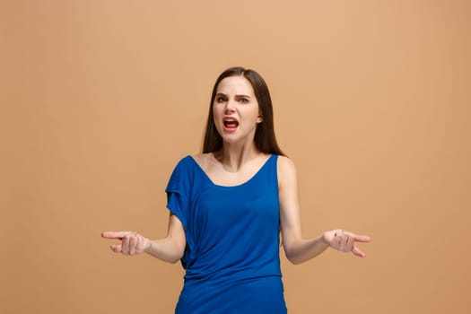 Screaming, hate, rage. Crying emotional angry woman screaming on pastel studio background. Emotional, young face. Female half-length portrait. Human emotions, facial expression concept. Trendy colors