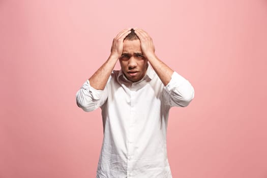 Horrible, stress, shock. Male half-length portrait isolated at pink studio. Young emotional surprised afro man clasping head in hands. Human emotions, facial expression concept. Trendy colors. Front view