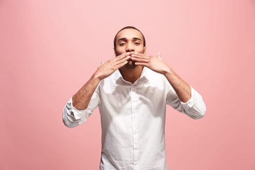 I kiss you. Portrait of attractive afro man with kiss on lips. Pink studio. Beautiful male portrait. Young happy emotional funny man looking at camera. Human facial emotions concept. Trendy colors