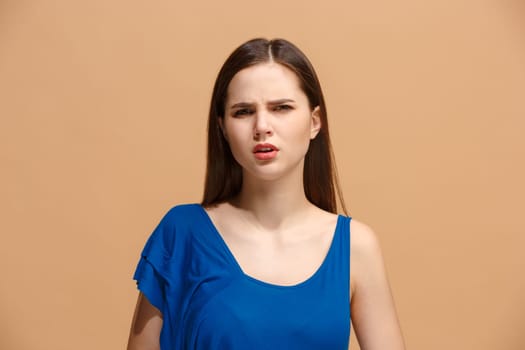 Reject, rejection, doubt concept. Disgust woman with thoughtful expression making choice. Young emotional woman. Human emotions, facial expression concept. Front . Studio. Isolated on trendy pastel