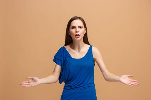 Argue woman. Aggressive angry business woman standing isolated on trendy pastel studio background. Female half-length portrait. Human emotions, facial expression concept. Front view.