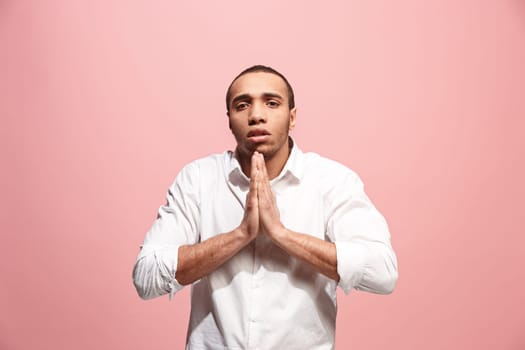 Why is that. Afro male half-length portrait isolated on trendy pink studio backgroud. Young emotional surprised, frustrated and bewildered man. Human emotions, facial expression concept.