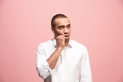 I am tired of everything. Bored man. Boring, dull, tedious concept. Young caucasian emotional afro man. Human emotions, facial expression concept. Studio shot isolated on trendy pink background
