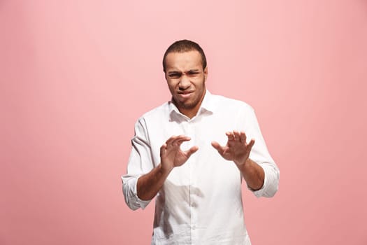 It's so gross. Young man with disgusted expression repulsing something. Disgust concept. Young afro emotional man. Human emotions, facial expression concept. Studio. Isolated on trendy pink color