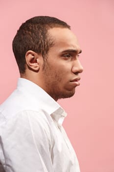 Why is that. Beautiful male half-length portrait isolated on trendy pink studio backgroud. Young emotional surprised, frustrated and bewildered afro man. Human emotions, facial expression concept. . Profile