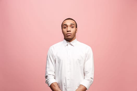 Let me think. Doubt concept. Doubtful pensive afro man with thoughtful expression making choice. Young emotional man. Human emotions, facial expression concept. Front . Studio. Isolated on trendy pink