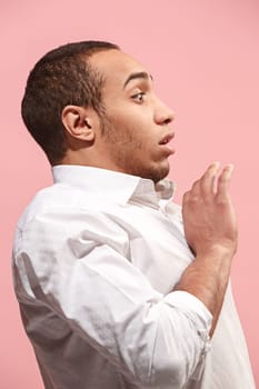 I'm afraid. Fright. Portrait of the scared man. Afro Business man standing isolated on trendy pink studio background. male half-length portrait. Human emotions, facial expression concept. . Profile view