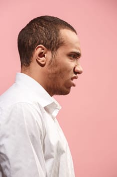 Screaming, hate, rage. Crying emotional angry afro man screaming on pink studio background. Emotional, young face. male half-length portrait. Human emotions, facial expression concept. Trendy colors. . Profile