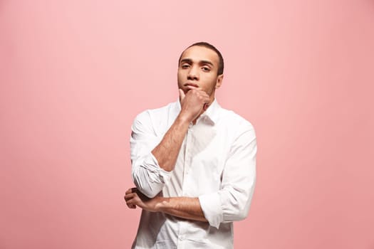Remember all. Let me think. Doubt concept. Doubtful, thoughtful afro man remembering something. Young emotional man. Human emotions, facial expression concept. Studio. Isolated on trendy pink. Front