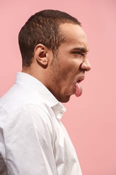 It's so gross. Young man with disgusted expression repulsing something. Disgust concept. Young emotional afro man. Human emotions, facial expression concept. Studio. Isolated on trendy pink color. Profile